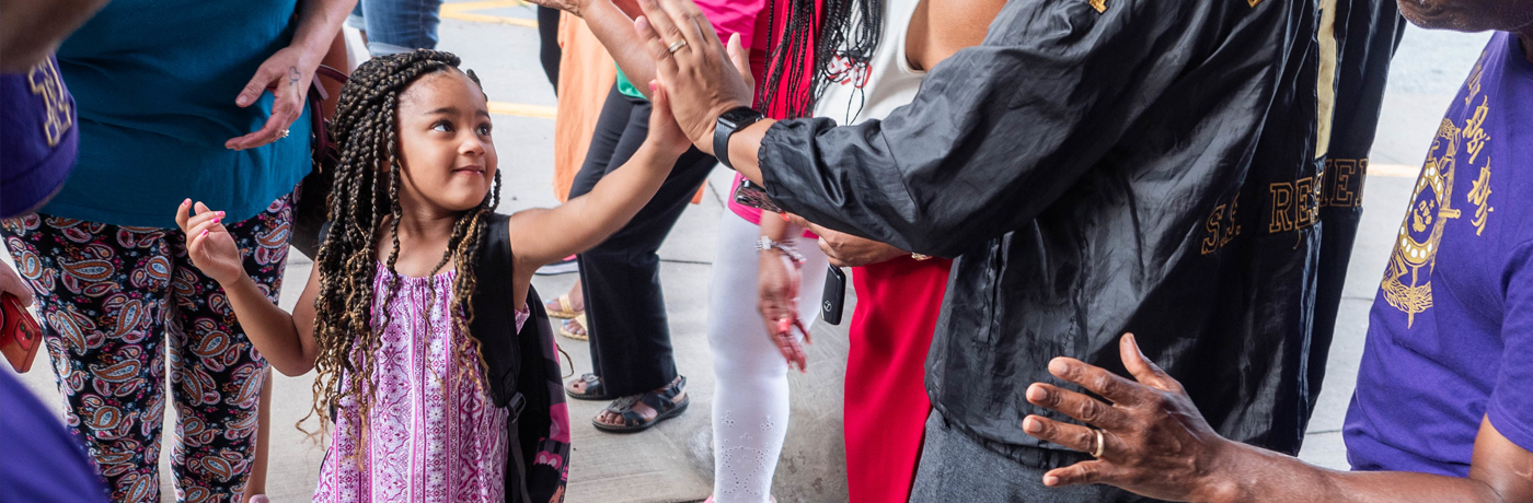 student giving a teacher a high five